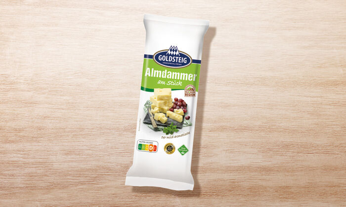 Almdammer Stück - GOLDSTEIG Käsespezialitäten Almdammer Stück von GOLDSTEIG in Verpackung
